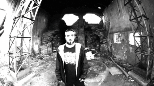 a black and white photo of a man wearing a black shirt that says ' rage '