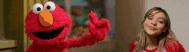 elmo is giving a thumbs up next to a woman in a red shirt