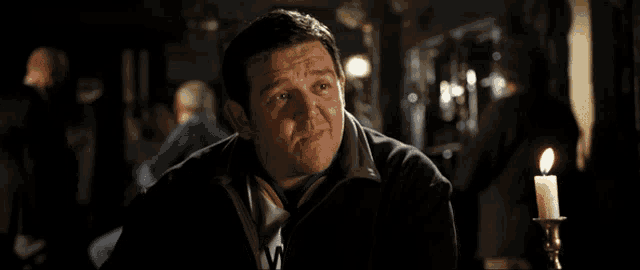 a man says what a cunt in front of a candle