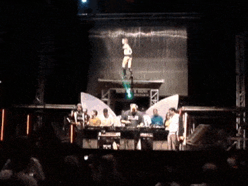 a group of people on a stage with one wearing a black shirt that says blaze