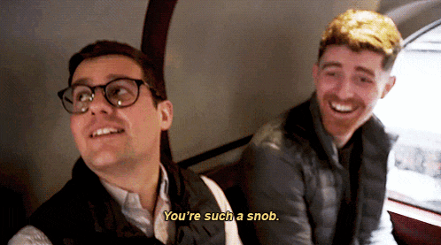 a man with glasses says " you 're such a snob " to another man