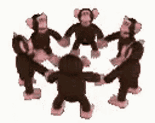 a group of stuffed monkeys are standing in a circle holding hands .