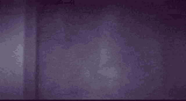 a ghost with a mask on his face is standing in front of a door .