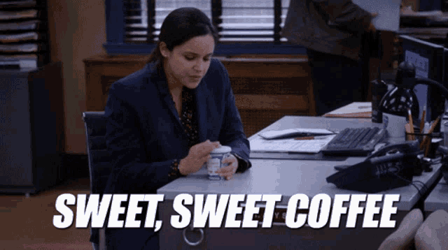 a woman sits at a desk with a cup of coffee and the words sweet sweet coffee written below her