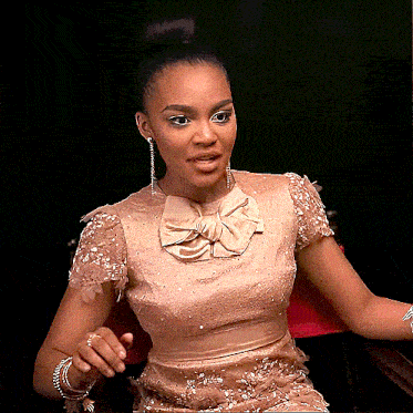 a woman wearing a dress with a bow on the collar