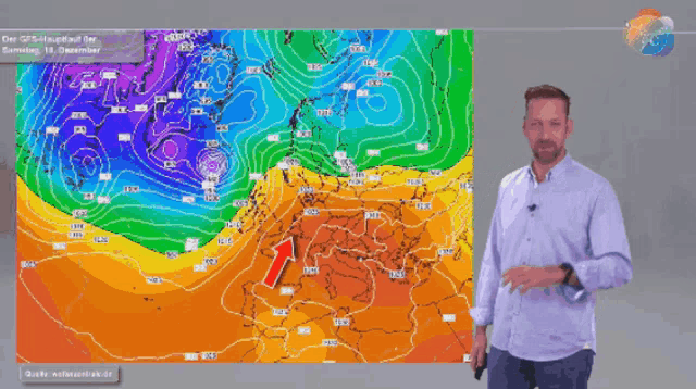a man stands in front of a weather map with arrows pointing to different directions