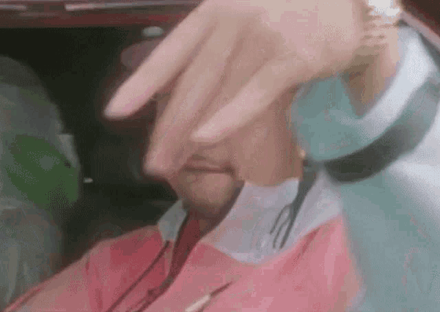a close up of a person 's hand covering their face .