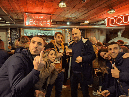 a group of people standing in front of a sign that says liquor locker
