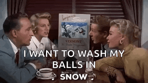 a group of people are sitting at a table with a sign that says `` i want to wash my balls in snow `` .