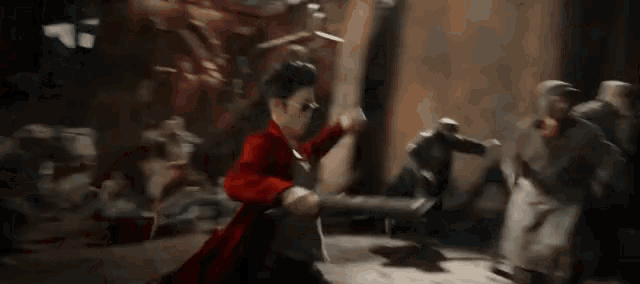 a man in a red coat is fighting a group of people in a painting .
