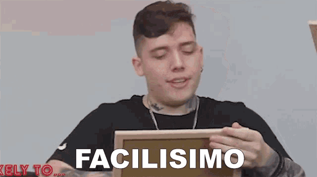 a young man is holding a wooden box with the word facilisimo on it .