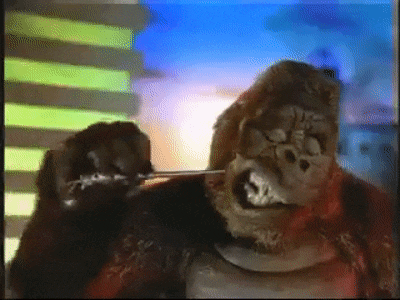 a gorilla is standing in front of a building .