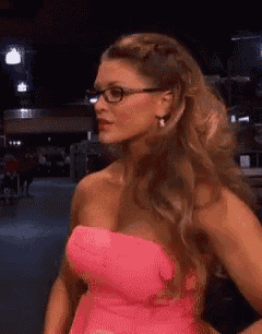 a woman in a pink strapless dress with glasses on