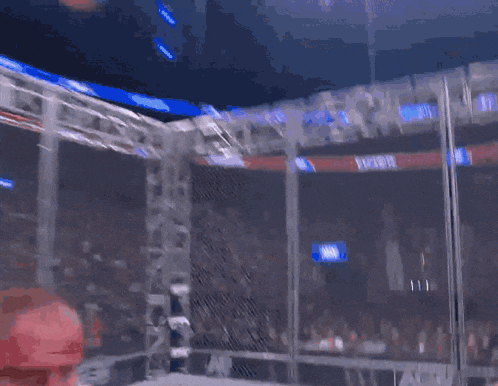 a shirtless man with blood on his face is standing in front of a crowd