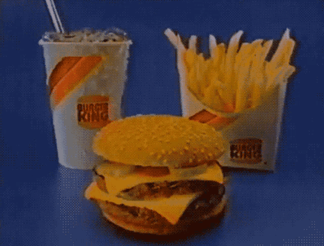 a burger king hamburger and french fries are on a table