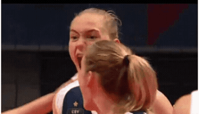 a group of women are playing volleyball and one of them is wearing a jersey that says cev .