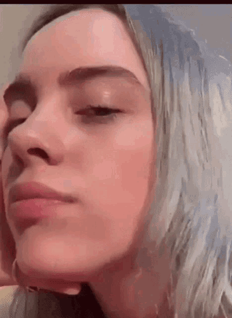 a close up of a woman 's face with a blurred background .