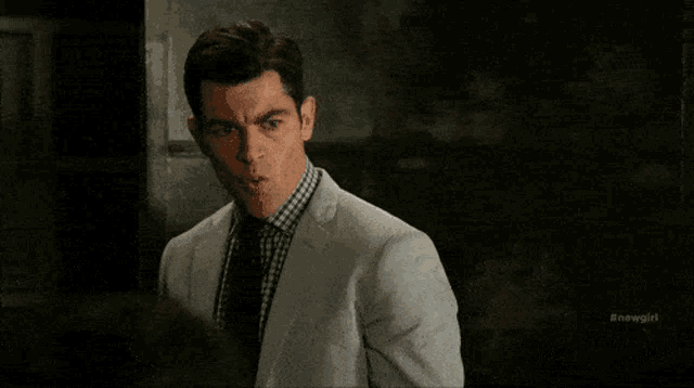 a man in a suit and tie is screaming with the words winter is coming behind him
