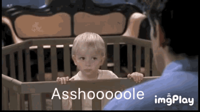 a baby in a crib with the words asshoooole on the bottom right