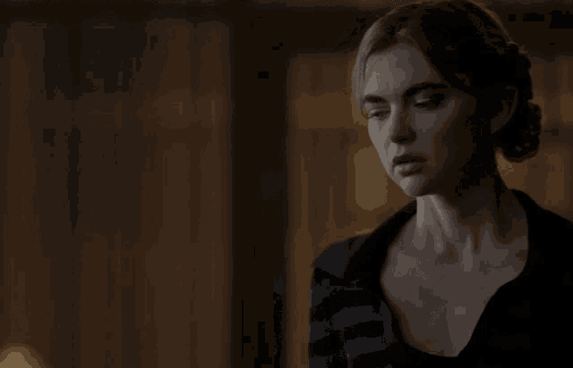 a woman in a plaid shirt is looking to the side