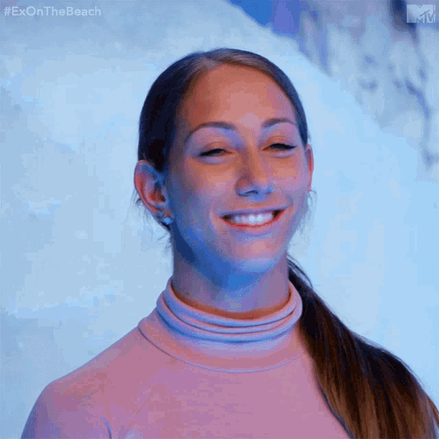 a woman is smiling in front of a blue background with the hashtag #exonthebeach