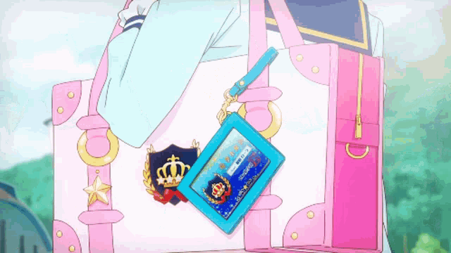 a pink and white purse with a blue badge that says ' a ' on it