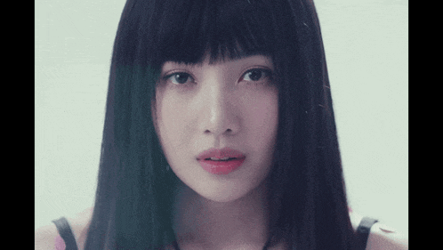 a close up of a woman 's face with black hair