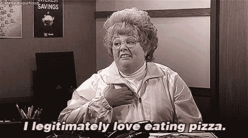 a woman is sitting at a desk and saying i legitimately love eating pizza