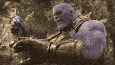 thanos from avengers infinity war is holding a piece of infinity stone