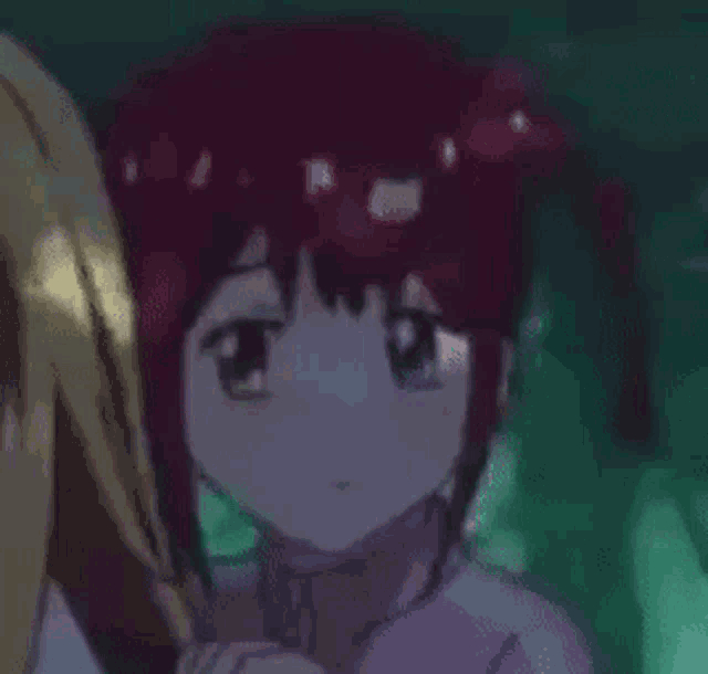 a girl with red hair is standing next to a girl in a purple sweater .