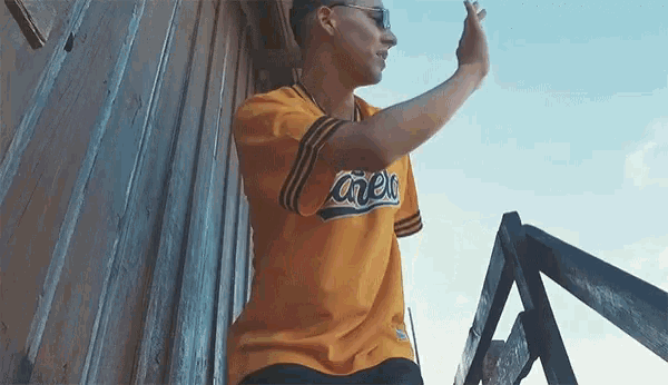 a man wearing a yellow jersey that says crew on it