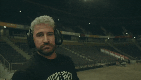 a man wearing headphones and a shirt that says new york bench