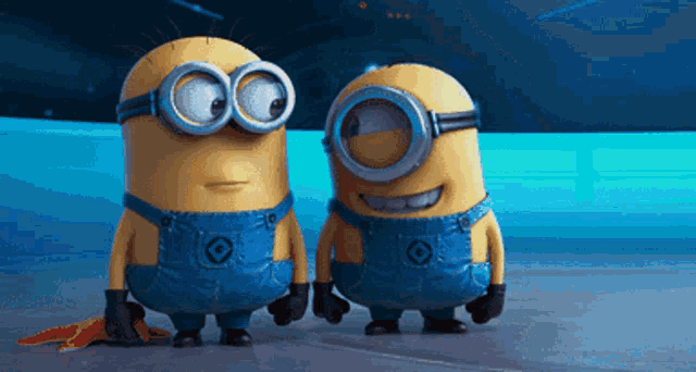 two minions are standing next to each other and one has a banana on his back