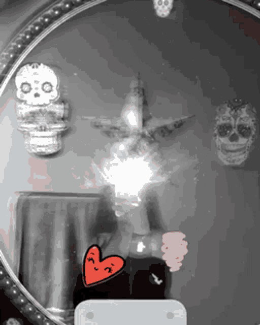 a black and white photo of a mirror with sugar skulls on it