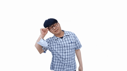 a man wearing glasses and a mask holds his hand to his head