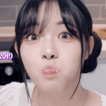 a close up of a girl making a funny face with the letter o on the bottom