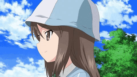 a girl wearing a baseball cap stands in front of a blue sky with clouds