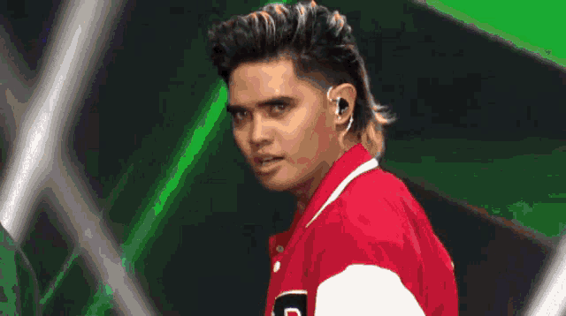 a man in a red jacket with the letter d on the sleeve