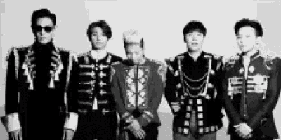 a black and white photo of a group of men standing next to each other .