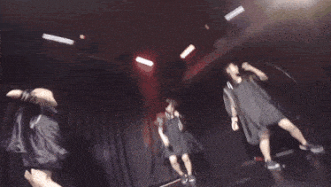 a blurry photo of people dancing in a dark room