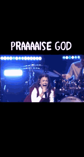 a girl singing in front of a drum set with the words praaaase god below her