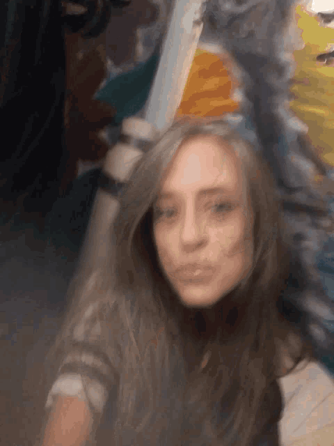 a blurry picture of a woman with long hair making a funny face