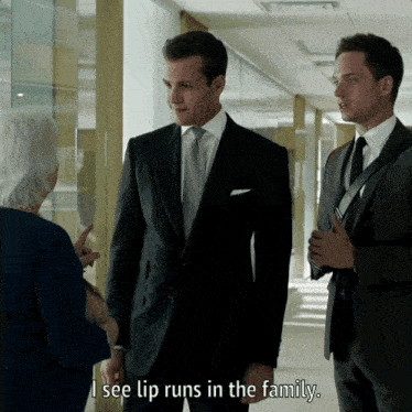 a man in a suit says " i see lip runs in the family " in a hallway