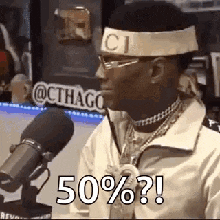 a man wearing a headband and glasses is sitting in front of a microphone and saying `` 50 % ? '' .
