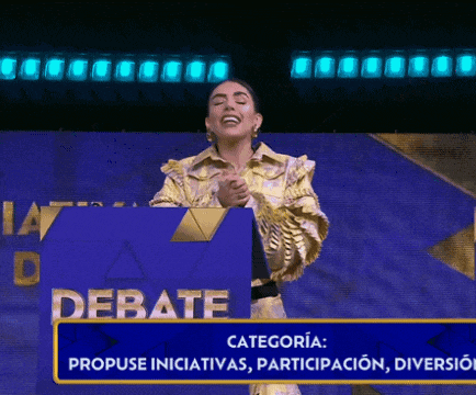 a woman stands behind a podium that says debate on it