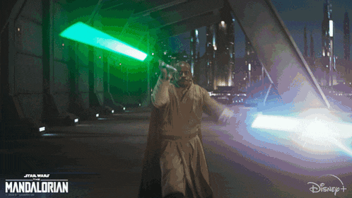 a poster for star wars the mandalorian shows a man holding a lightsaber