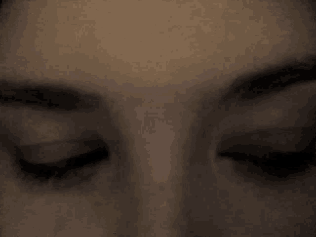 a close up of a woman 's eyes with a surprised look