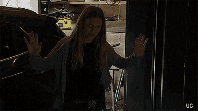 a woman standing in a dark room with the words my name 's hailey i 'm a police officer