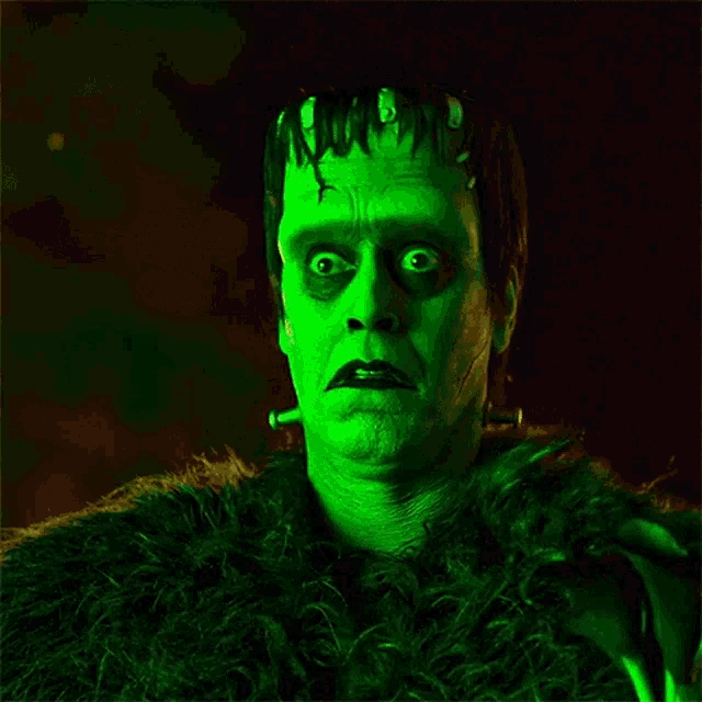 a man with green paint on his face and a green furry coat