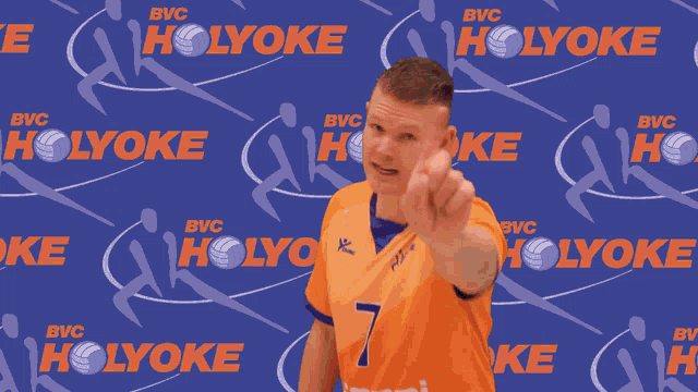 a man wearing an orange jersey with the number 7 on it